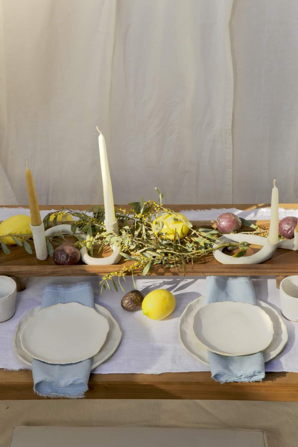 Springtime Tablescape with various Alliyah and Things products (Beewax taper candles, blue linen napkins, Stone with dinnerware set, White ceramic cups, stone double candle holder)