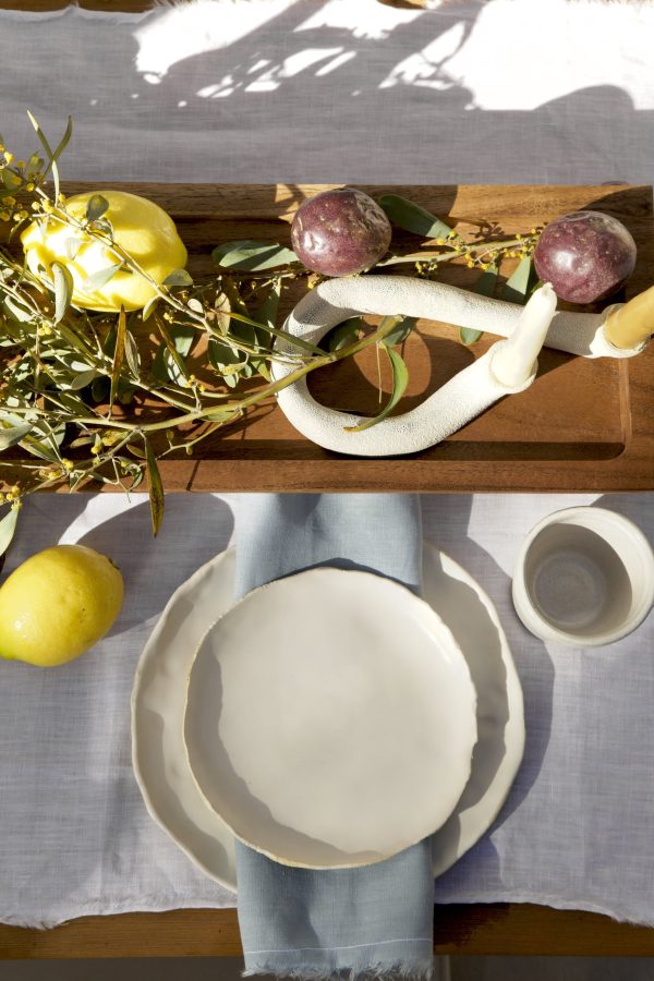 Springtime Tablescape with various Alliyah and Things products (Beewax taper candles, blue linen napkins, Stone with dinnerware set, White ceramic cups, stone double candle holder)