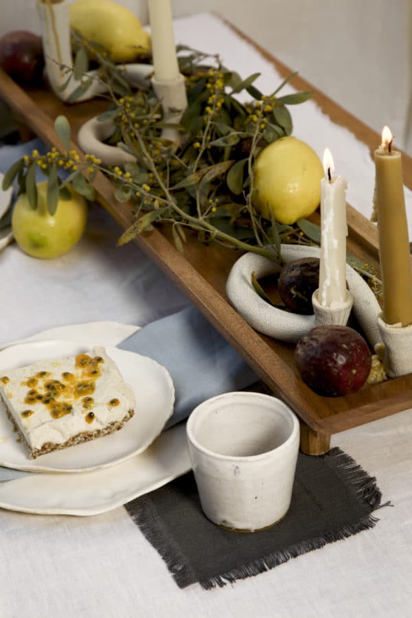 Springtime Tablescape with various Alliyah and Things products (Beewax taper candles, blue linen napkins, Stone with dinnerware set, White ceramic cups, stone double candle holder)